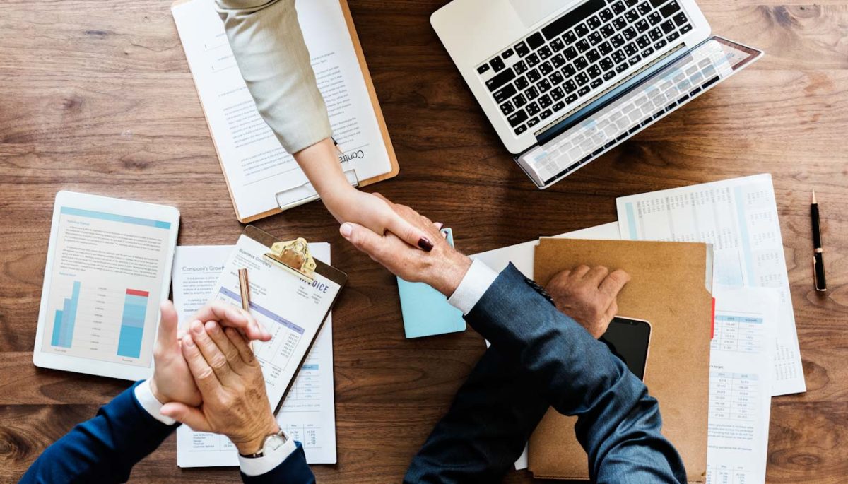 Business people shaking hands together